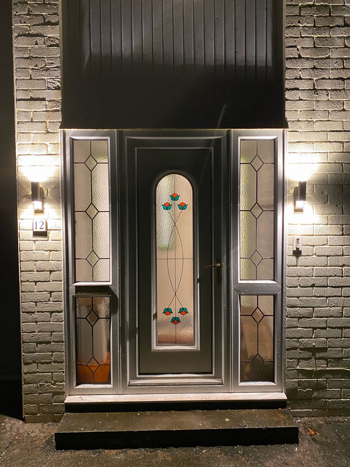 Front entrance — wall lights at dusk